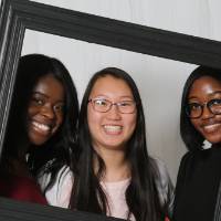 3 girls pose for pic with frame
